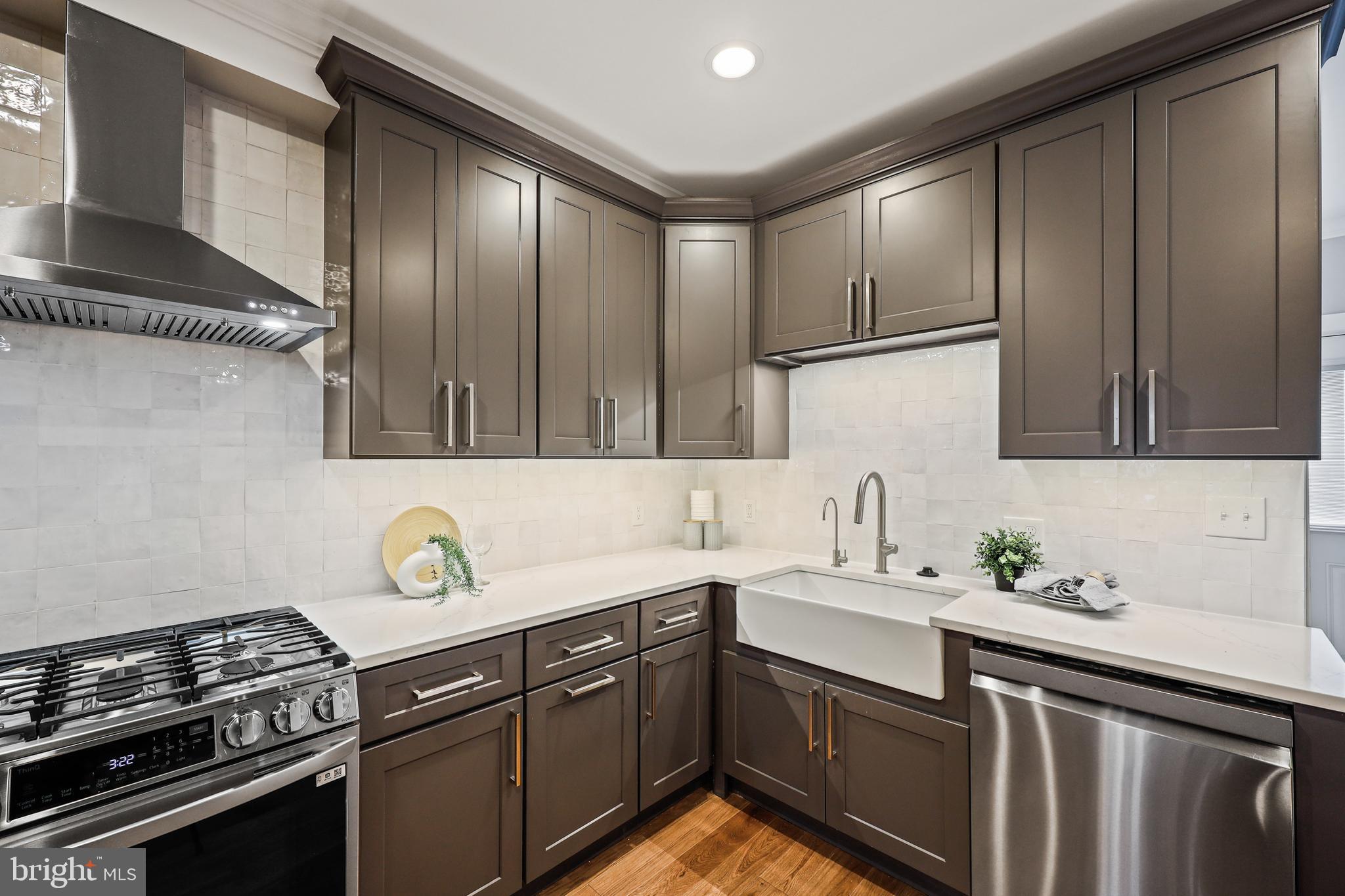 1465 Towson Street Baltimore, MD 21230 - Photo 10 of 39 a kitchen with a sink stove and cabinets