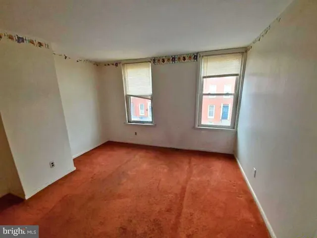 a bathroom with a sink a toilet a mirror and shower