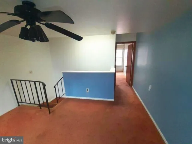 a view of an empty room with windows