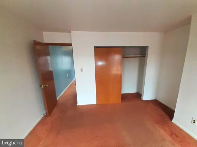 a view of a pathway of a house with wooden fence