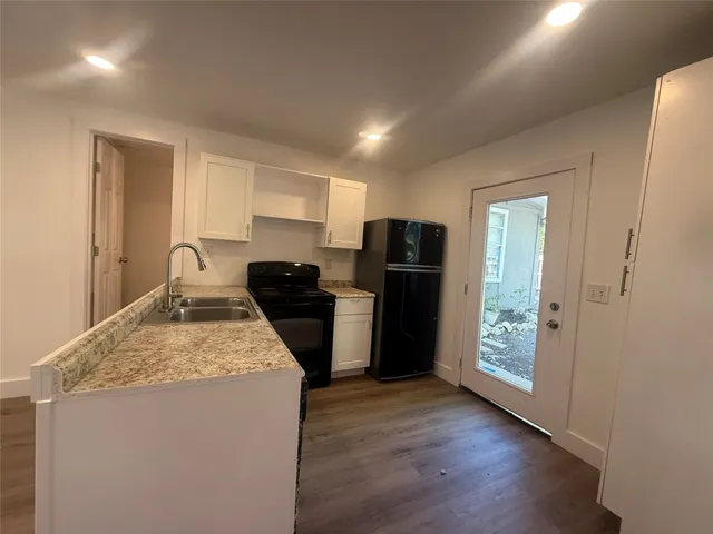 a kitchen with refrigerator and window