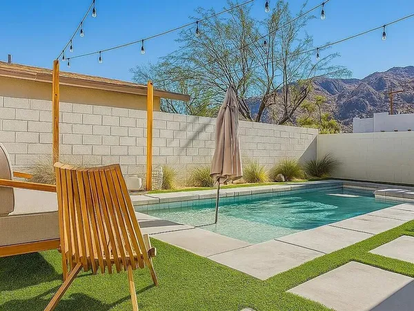 a view of backyard with swimming pool
