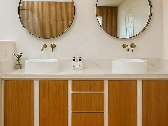 a bathroom with a sink a toilet and shower curtain