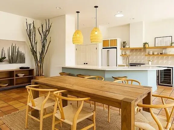 a kitchen with stainless steel appliances a stove a refrigerator and a white cabinets