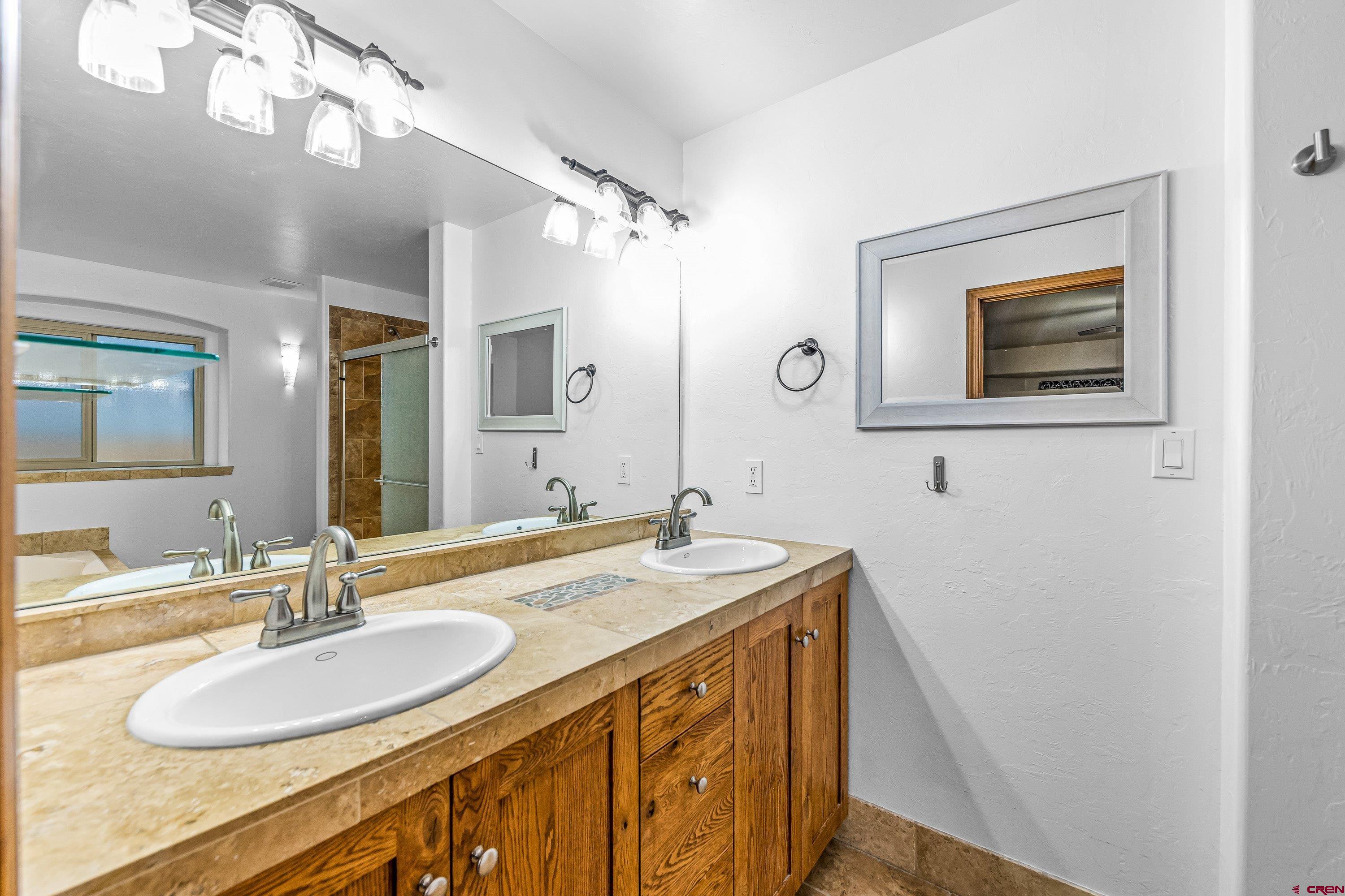 1455 Criterion Street Delta, CO 81416 - Photo 14 of 27 a bathroom with a sink a vanity and a mirror