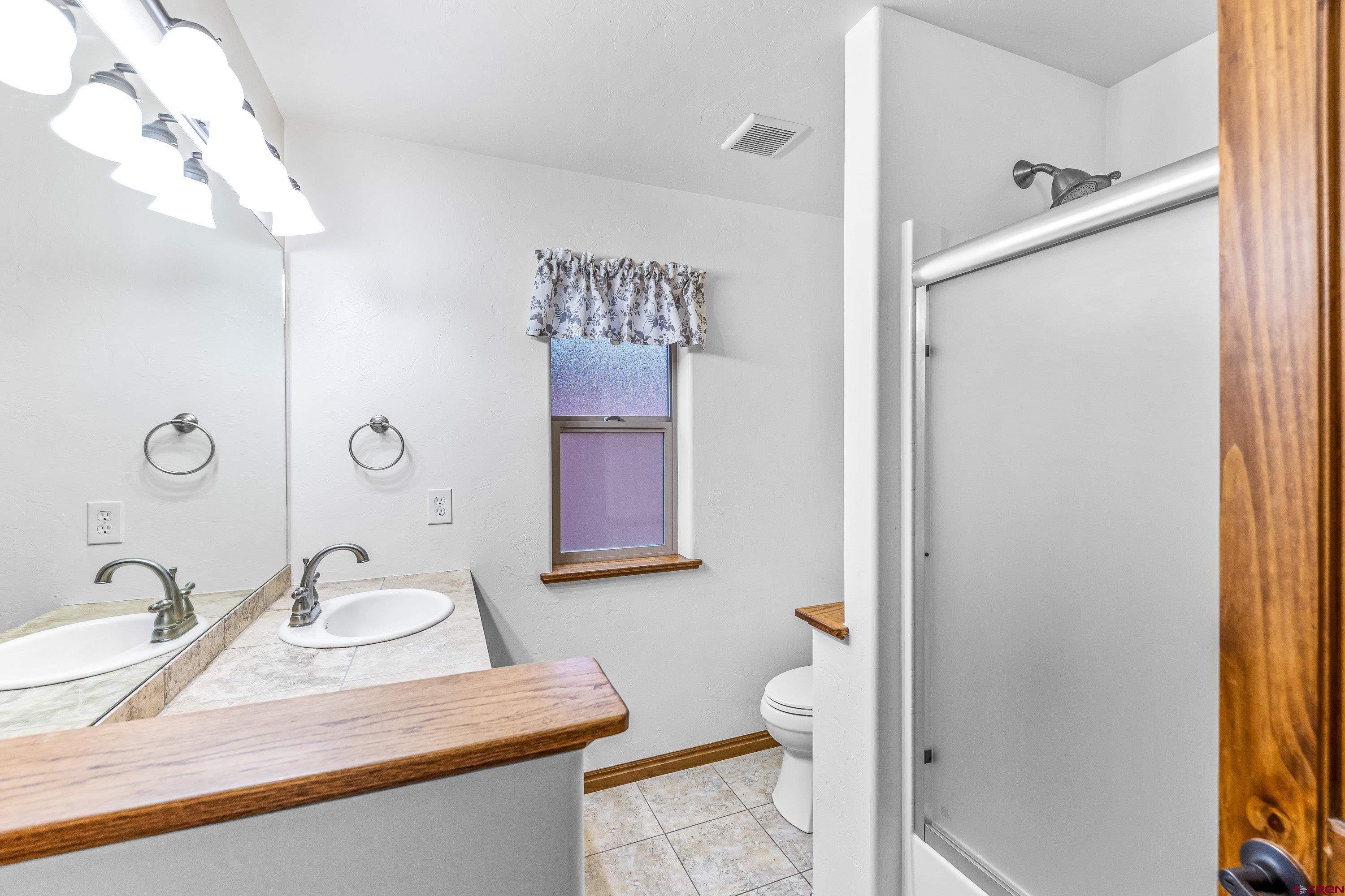 1455 Criterion Street Delta, CO 81416 - Photo 18 of 27 a bathroom with a sink toilet and shower