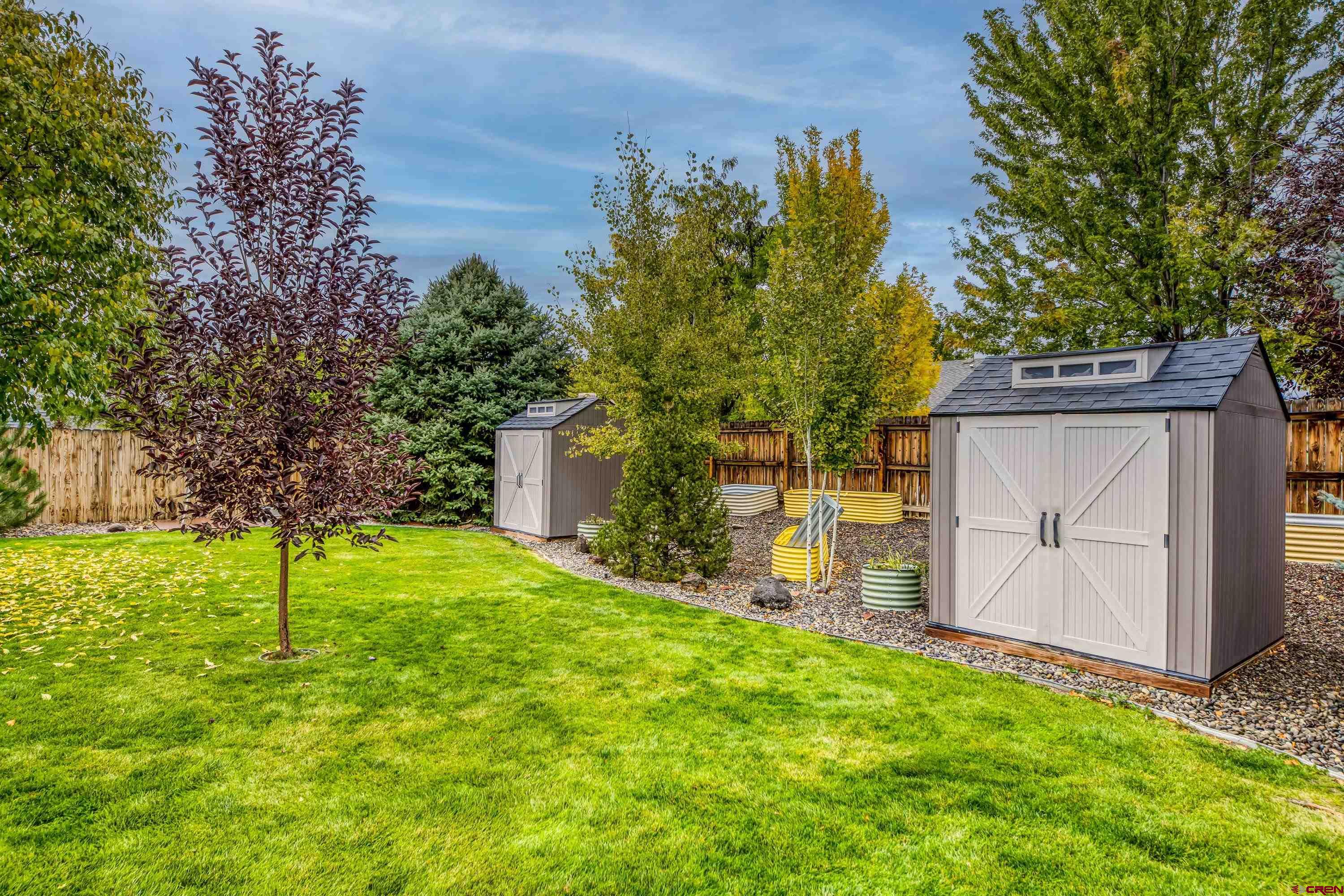 1455 Criterion Street Delta, CO 81416 - Photo 26 of 27 a backyard of a house with plants and wooden fence