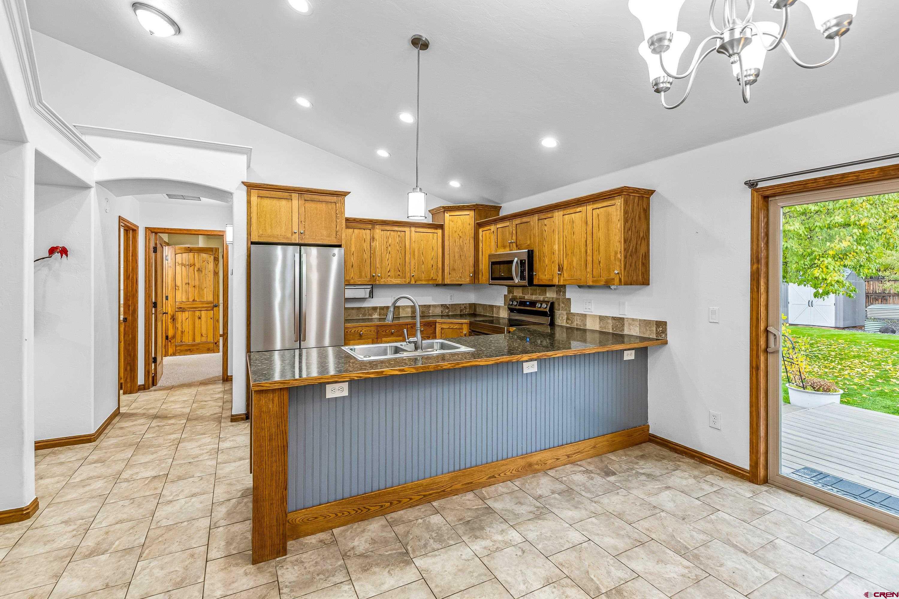 1455 Criterion Street Delta, CO 81416 - Photo 7 of 27 a view of kitchen with stainless steel appliances granite countertop a refrigerator and a sink