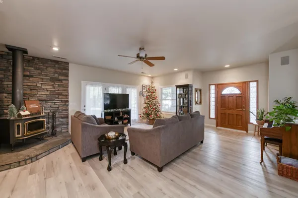 a living room with furniture flowers and a potted plant