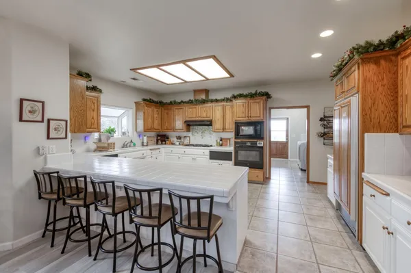a kitchen with white cabinets and white appliances