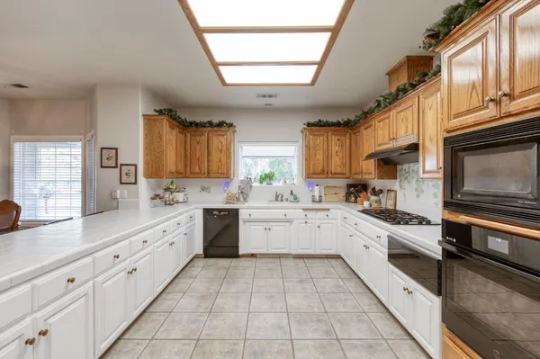 a kitchen with granite countertop cabinets and steel stainless steel appliances