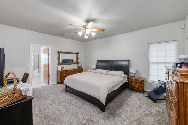 a bedroom with a bed and a television