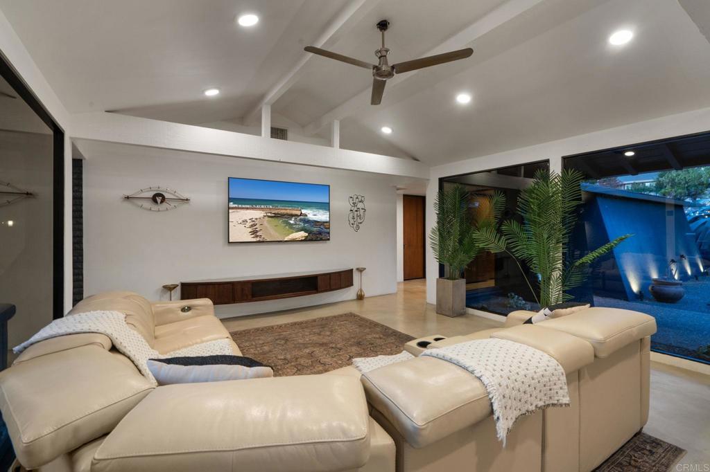 754 El Rancho Drive El Cajon, CA 92019 - Photo 14 of 55 a living room with furniture a floor to ceiling window and a flat screen tv