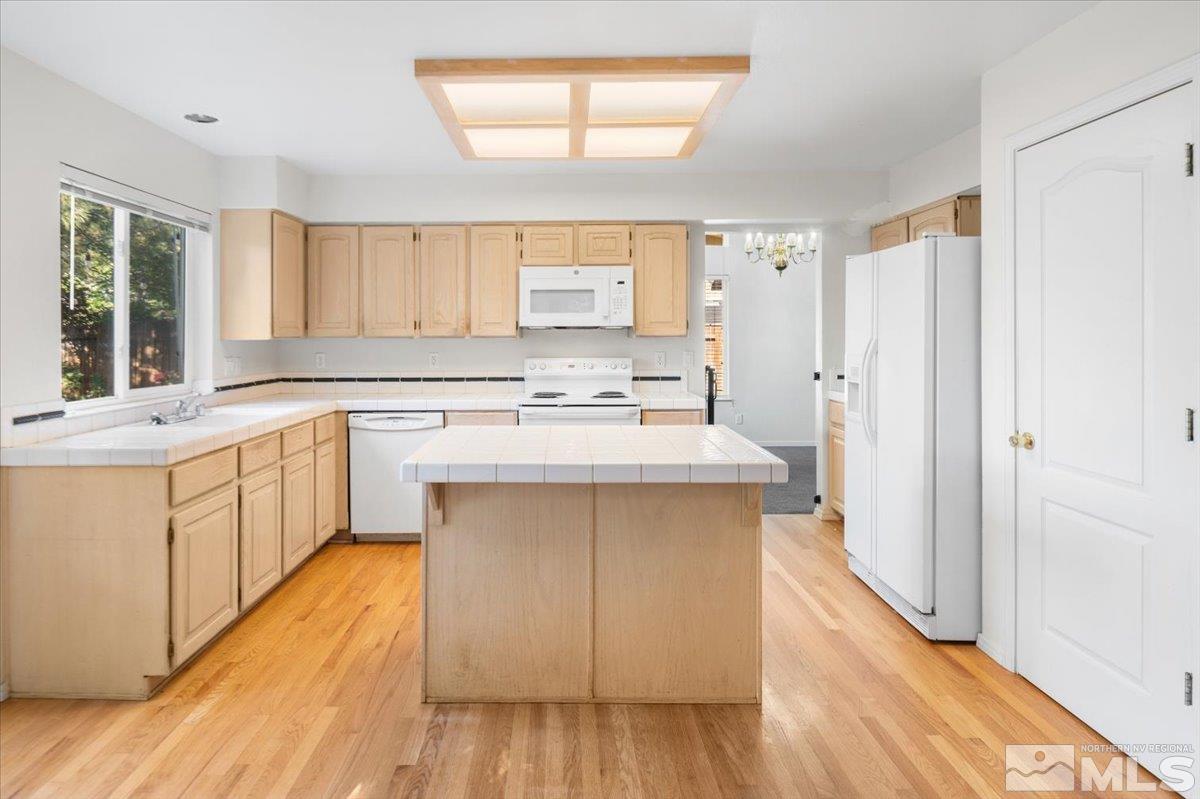 5850 Simons Drive Reno, NV 89523 - Photo 11 of 38 a kitchen with a sink cabinets appliances and a window