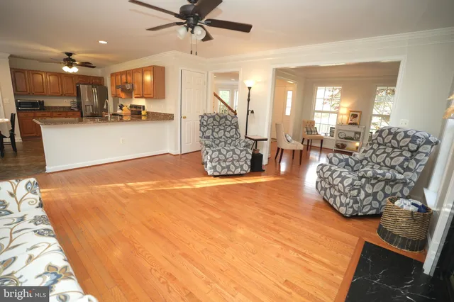 a living room with furniture and kitchen view