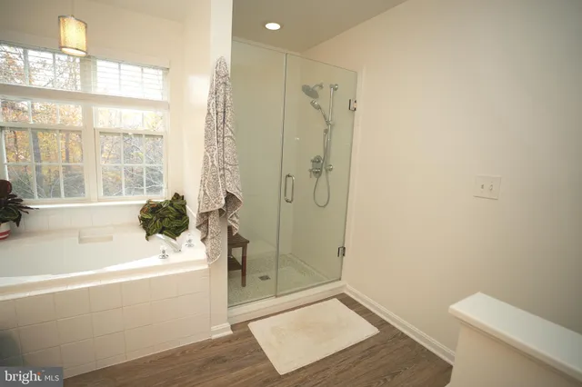 a bathroom with a bathtub and a shower