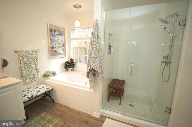 a bathroom with a granite countertop sink a toilet and shower