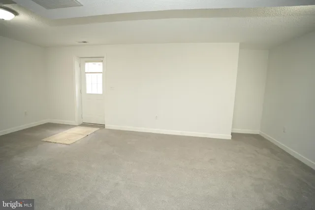 a view of an empty room and a window