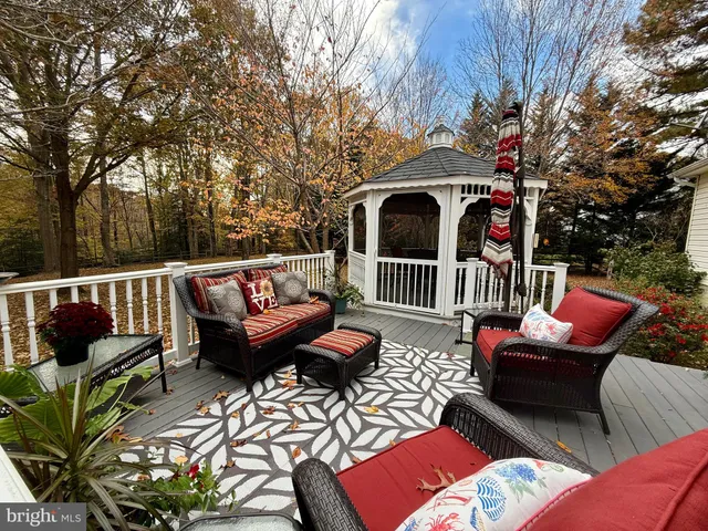 a view of a patio with couches table and chairs and a fire pit