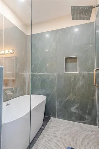 a bathroom with a bathtub and a shower