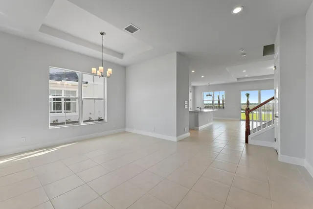 a large kitchen with kitchen island a large counter top stainless steel appliances and cabinets