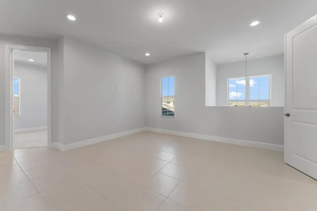 a bathroom with a granite countertop double vanity and a mirror