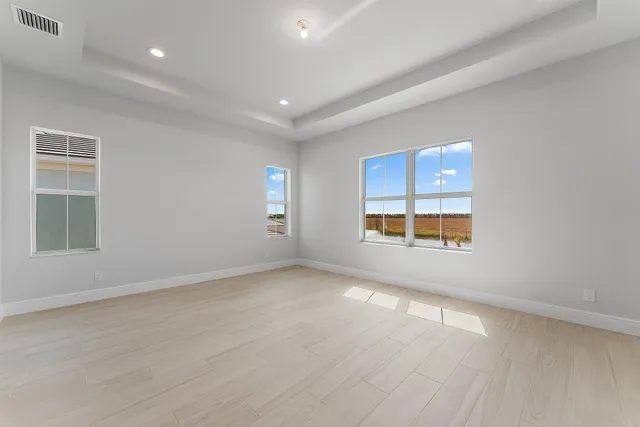 an empty room with windows and closet
