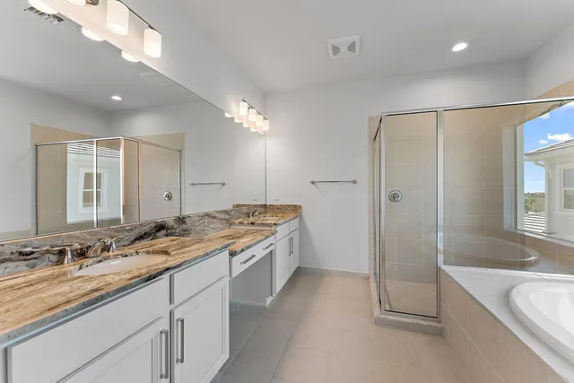 a view of a backyard with swimming pool and sitting area