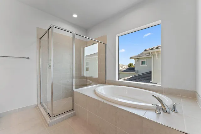 a living room with furniture a ceiling fan and a large window