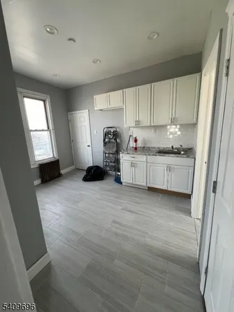 a kitchen with stainless steel appliances a stove top oven