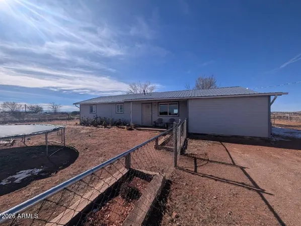a view of a backyard with furniture and stove