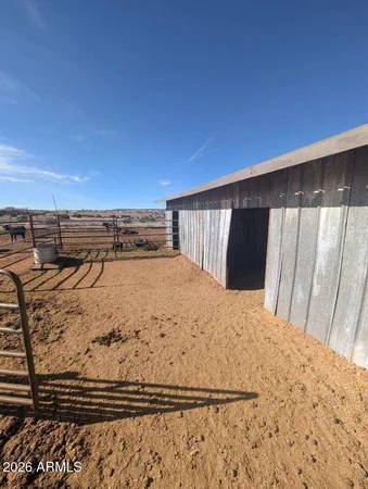 a view of a yard with wooden fence