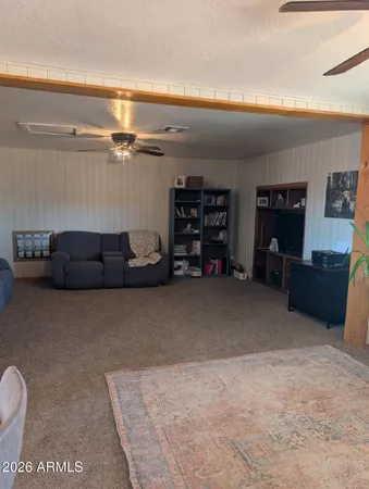 a living room with furniture a air conditioner and a rug
