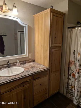 a bathroom with a granite countertop sink and a mirror