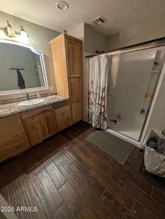 a bathroom with double vanity and a shower