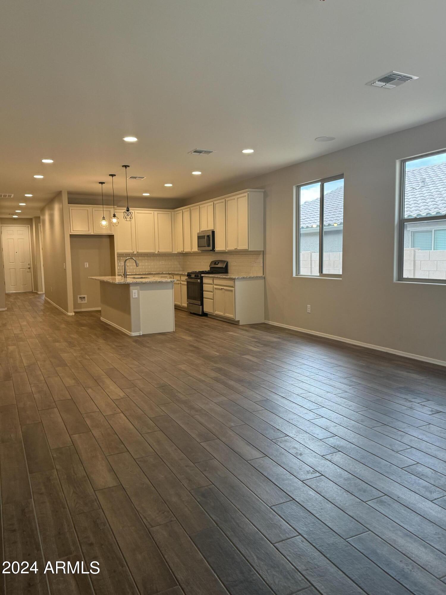 10207 South Moonlit Riverwalk Trail Vail, AZ 85641 - Photo 11 of 21 a view of kitchen with cabinets and wooden floor