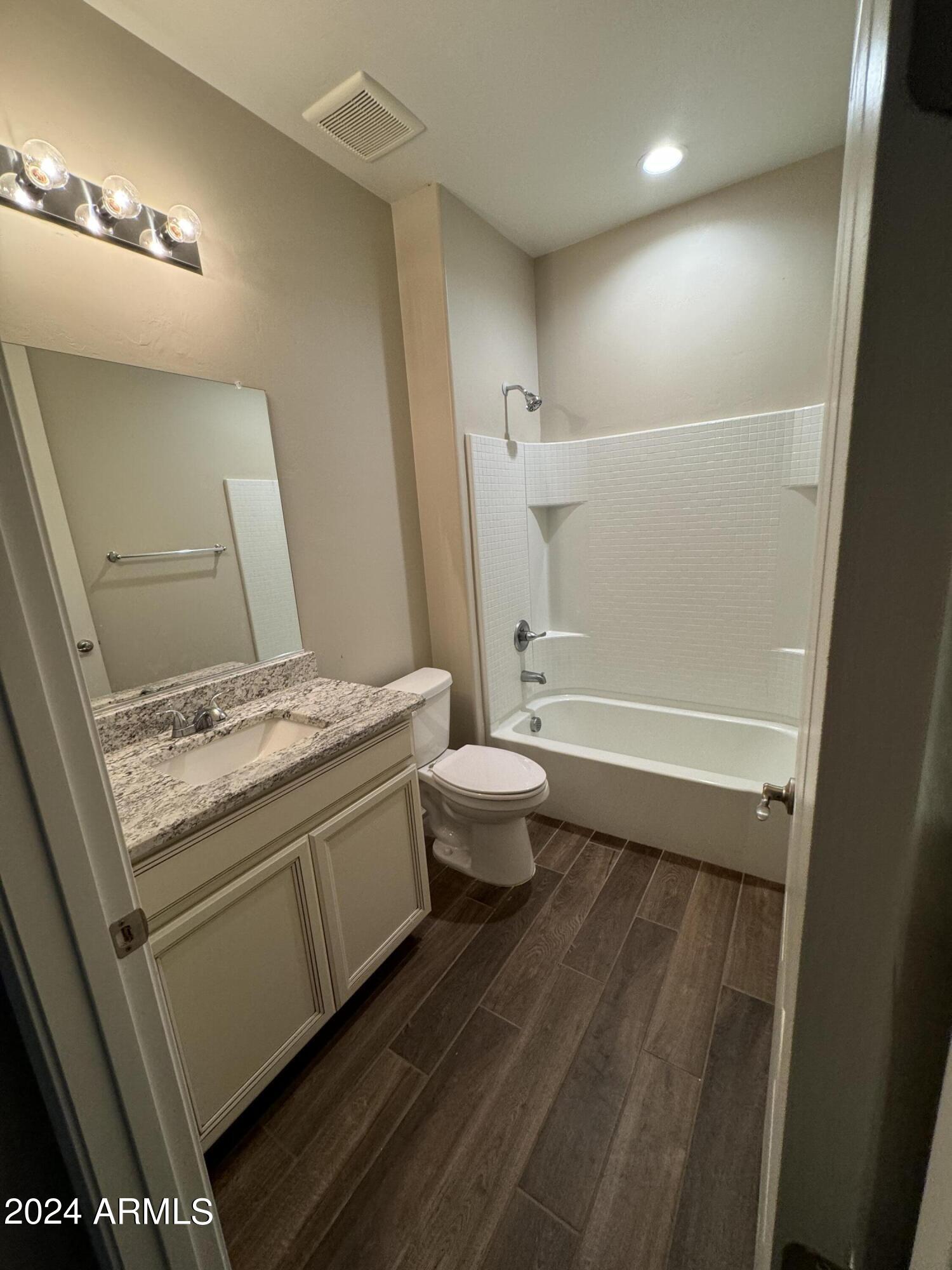10207 South Moonlit Riverwalk Trail Vail, AZ 85641 - Photo 4 of 21 a bathroom with a granite countertop sink toilet and shower