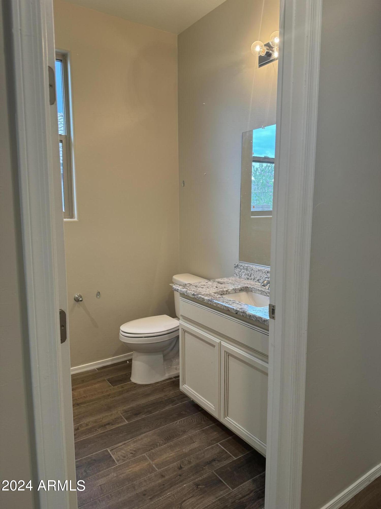 10207 South Moonlit Riverwalk Trail Vail, AZ 85641 - Photo 5 of 21 a bathroom with a granite countertop toilet and a sink