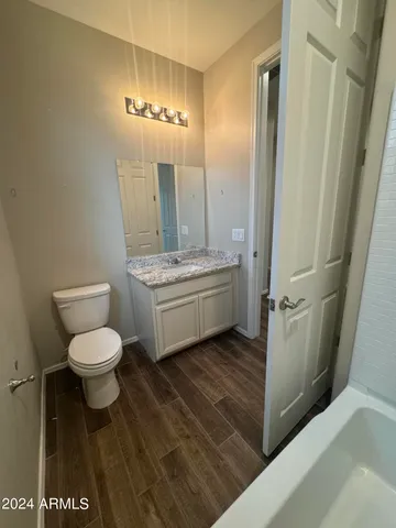 a bathroom with a toilet a sink and mirror