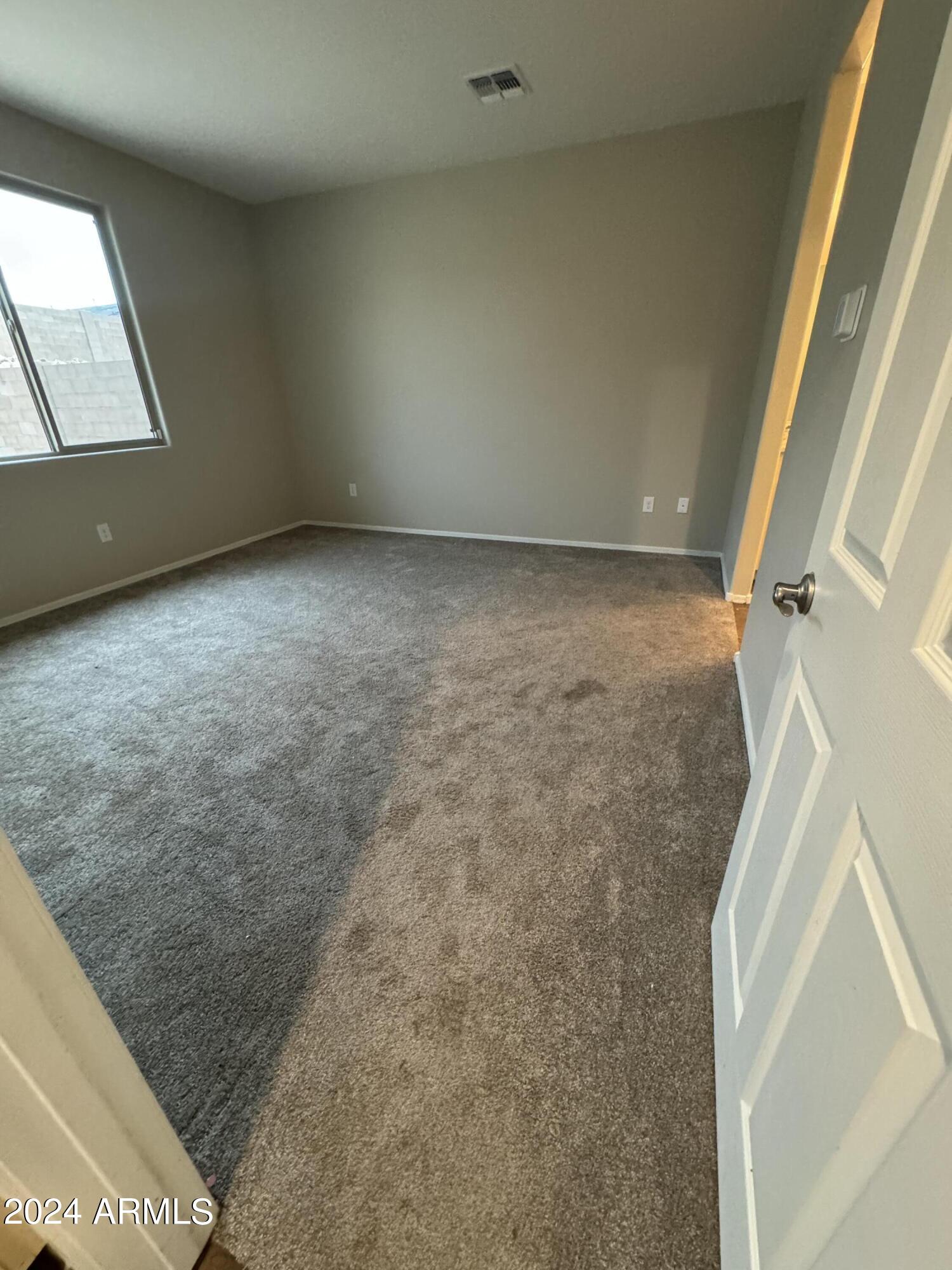 10207 South Moonlit Riverwalk Trail Vail, AZ 85641 - Photo 9 of 21 an empty room with wooden floor and windows