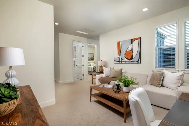a living room with furniture and a potted plant