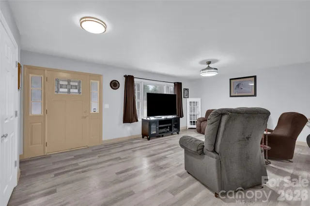 a view of a livingroom with furniture and a flat screen tv