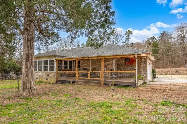 a view of a house with a backyard and a patio