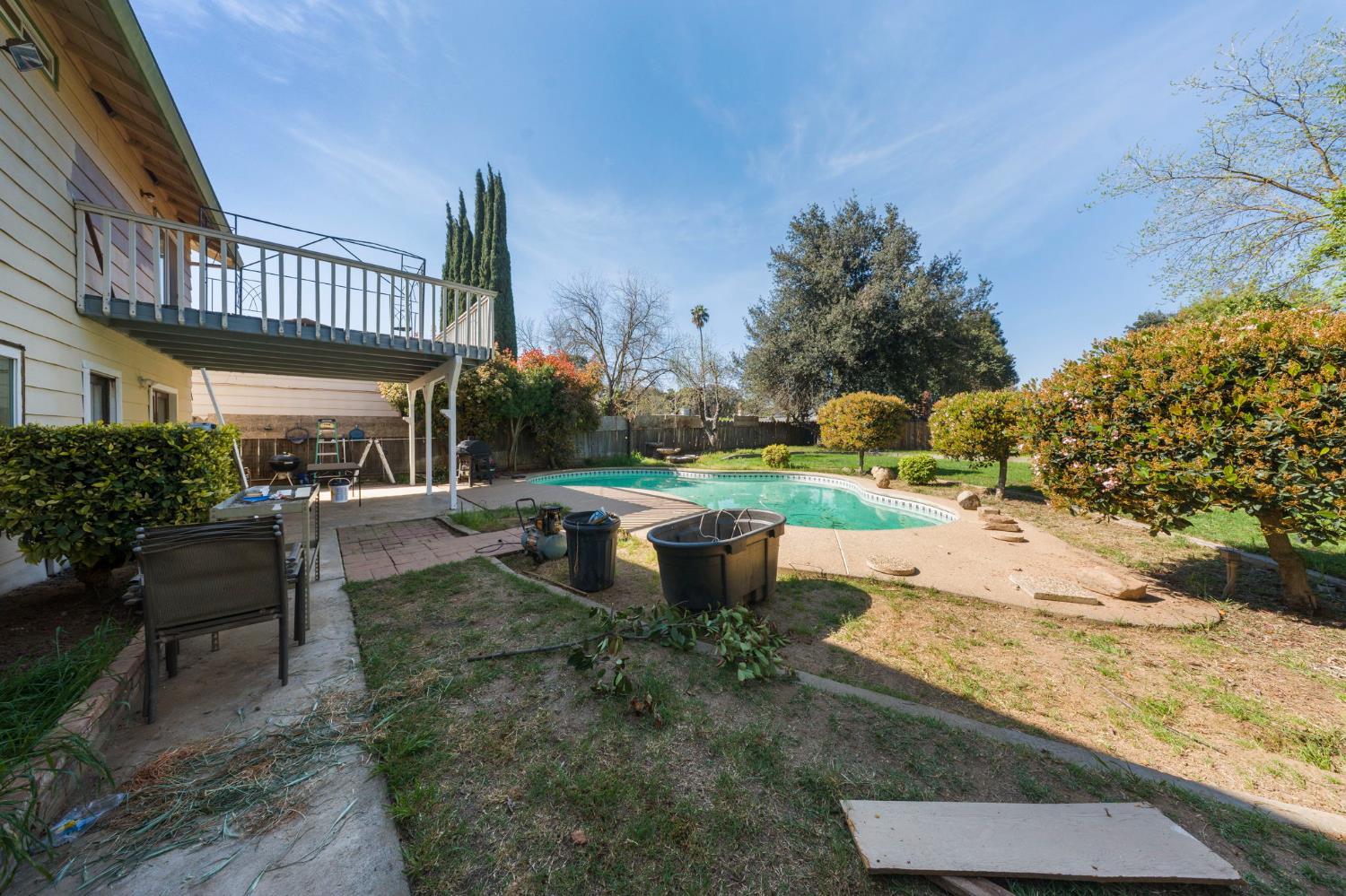 2779 Story Avenue Merced, CA 95340 - Photo 23 of 27 a view of a yard with table and chairs and potted plants