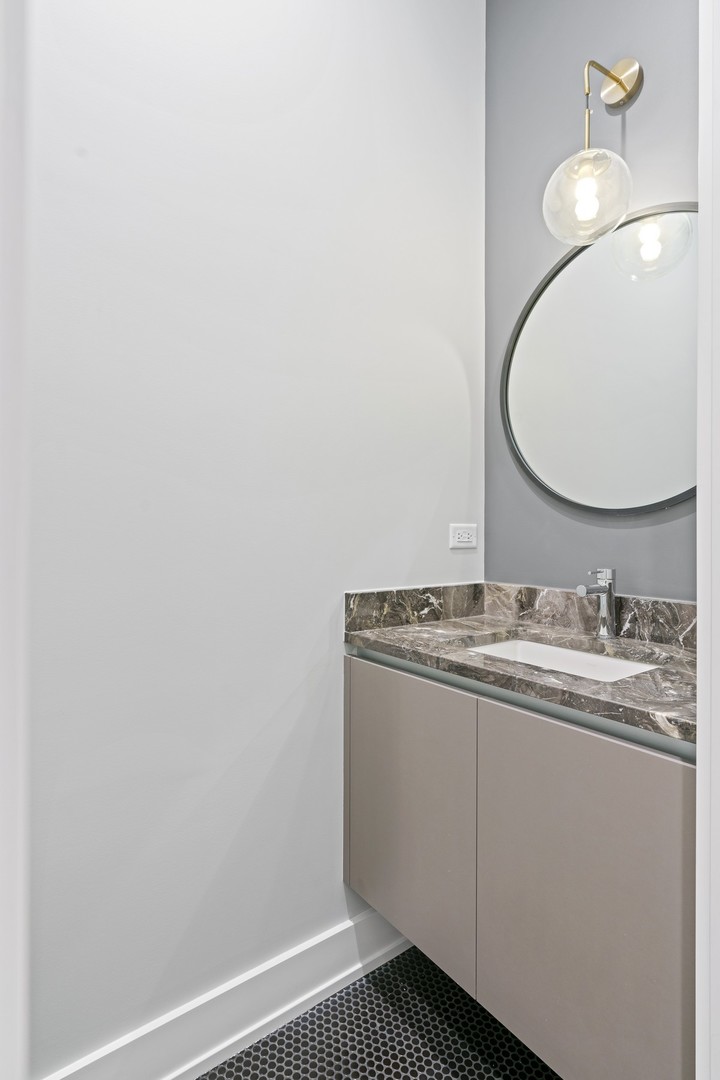 236 South Green Street, Unit 2S Chicago, IL 60607 - Photo 14 of 15 a bathroom with a sink and a mirror