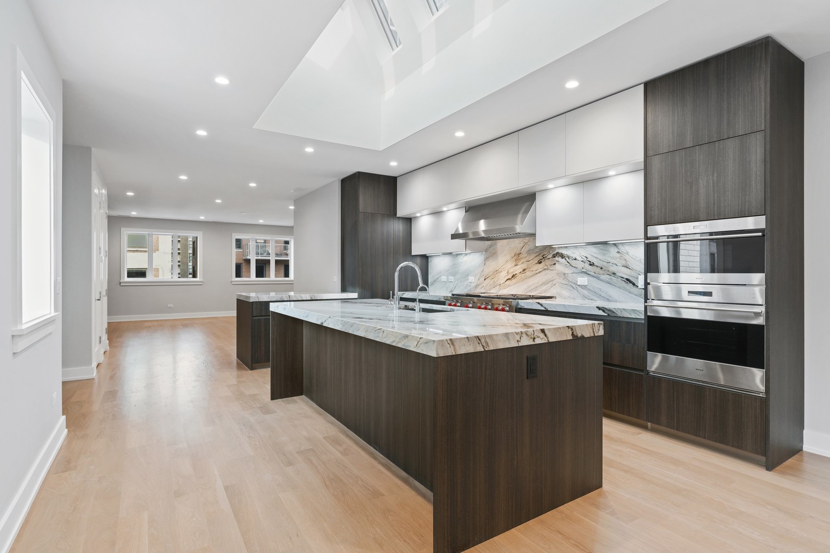 236 South Green Street, Unit 2S Chicago, IL 60607 - Photo 3 of 15 a kitchen with stainless steel appliances granite countertop a lot of counter space and wooden floor
