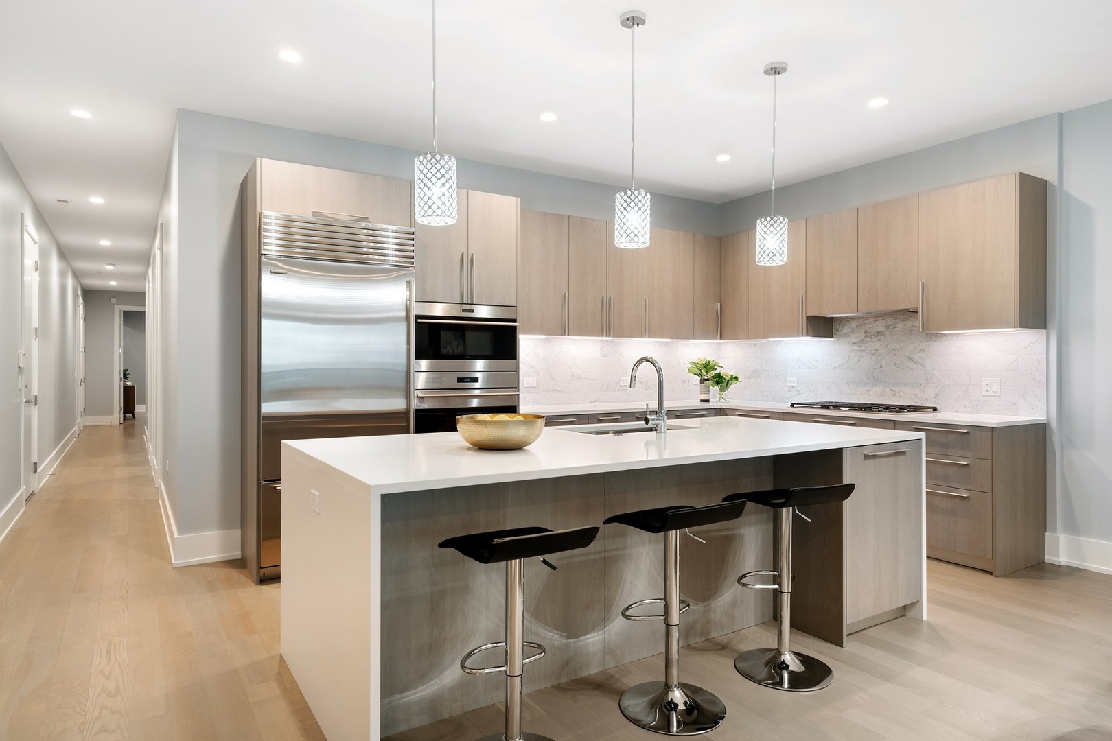 236 South Green Street, Unit 2S Chicago, IL 60607 - Photo 4 of 15 a kitchen with kitchen island granite countertop a sink a center island stainless steel appliances and cabinets