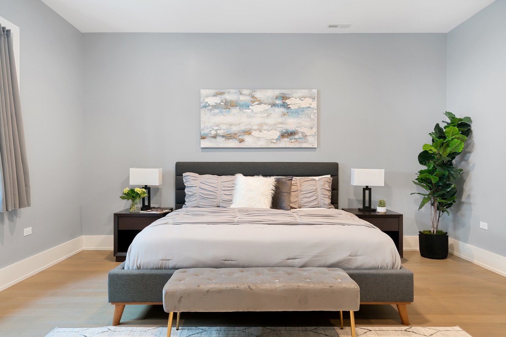 236 South Green Street, Unit 2S Chicago, IL 60607 - Photo 8 of 15 a bedroom with a bed a painting on the wall and a potted plant