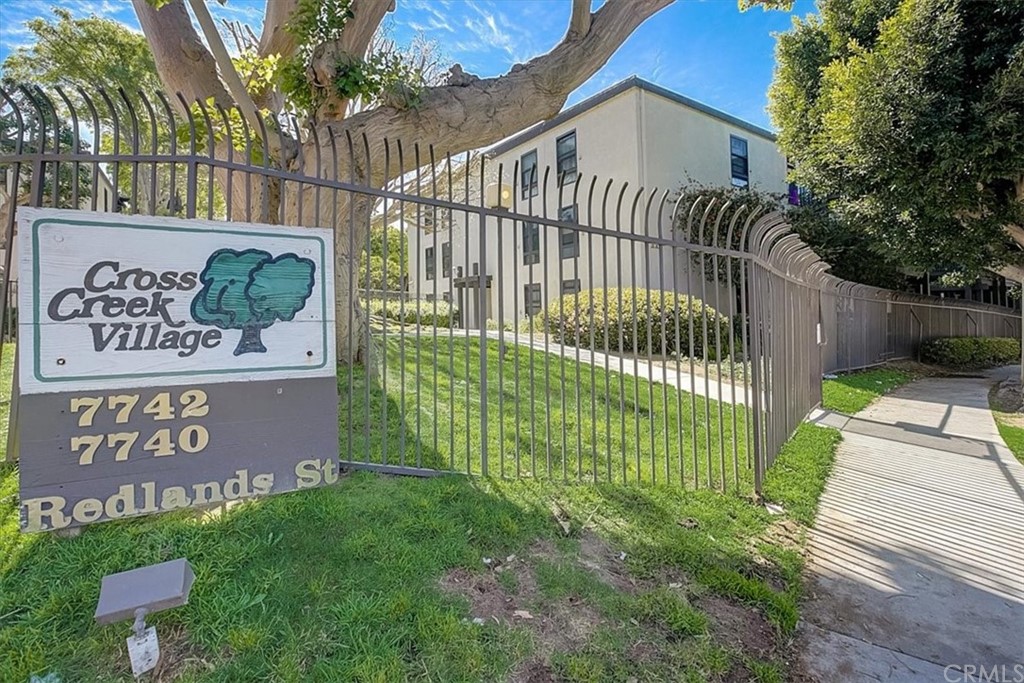 7740 Redlands Street, Unit G2083 Playa del Rey, CA 90293 - Photo 1 of 1 a view of a house with a small yard and wooden fence