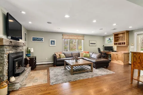 a living room with fireplace furniture and a flat screen tv